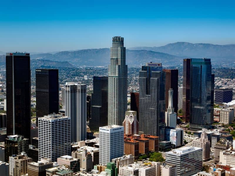 Downtown Los Angeles skyline with high-rise buildings and surrounding mountains representing Los Angeles land surveying services