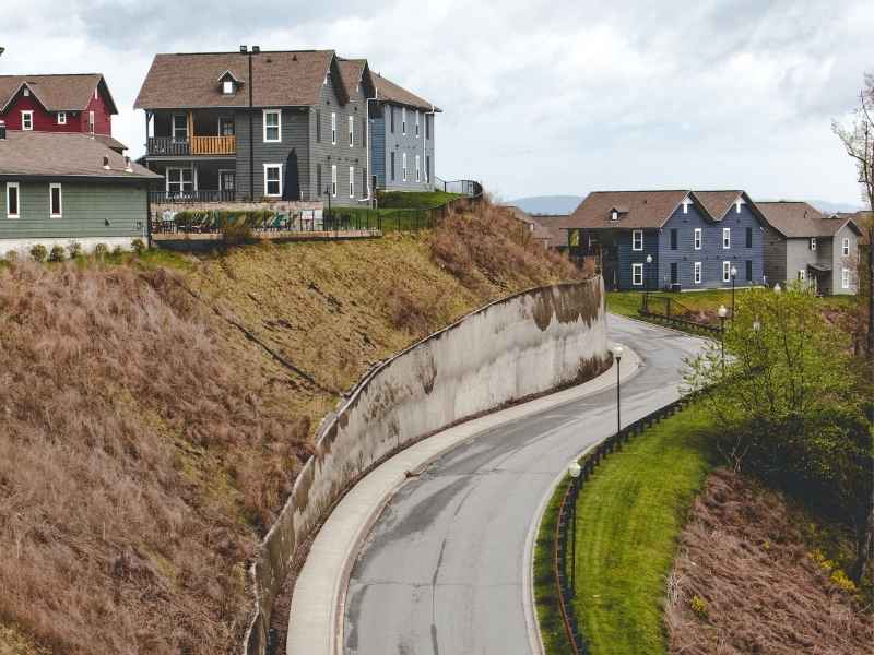 Steep hillside development with elevation changes and retaining walls illustrating topographic survey needs for drainage planning in Los Angeles, California.